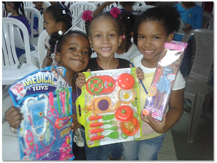Children smiling holding their gifts.