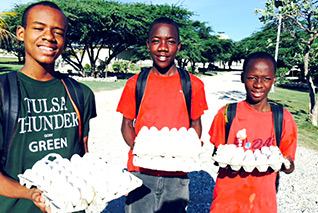 Orphans gather eggs at Love A Child's chicken farm in Haiti