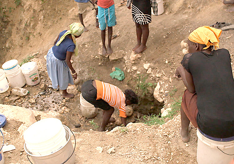 Women collecting water at the water hole.