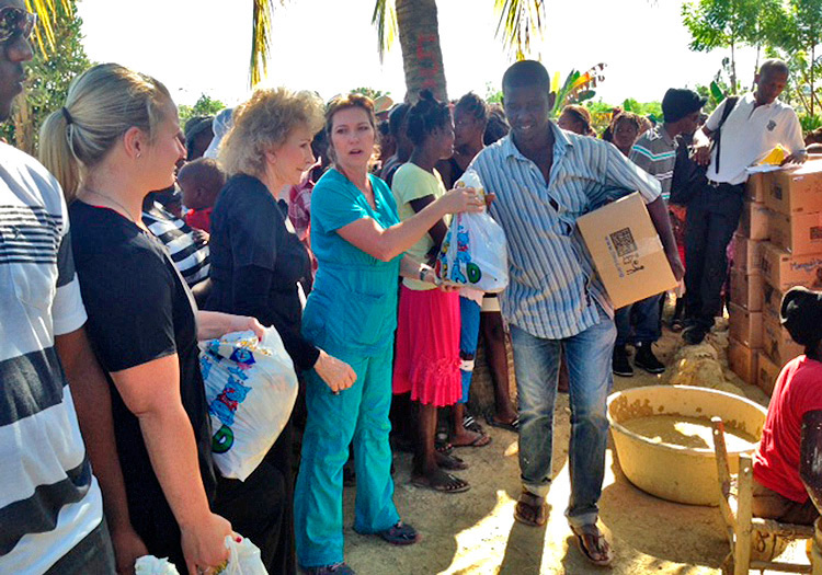 Julie helping with food distributions in poor village of Sapaterre.