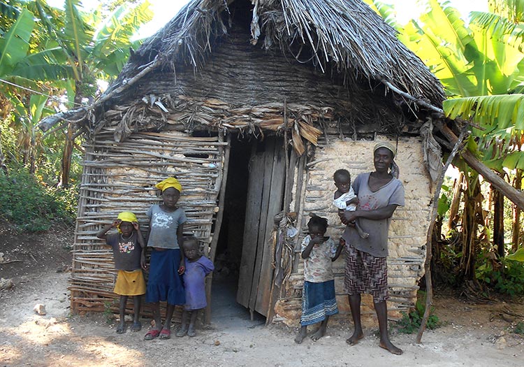 Very poor Haitian family living in a stick hut.