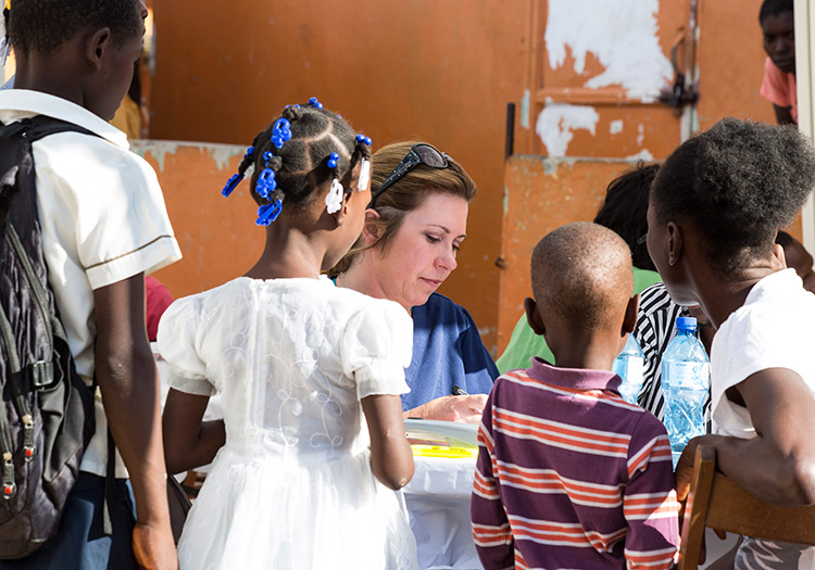 Julie with Haitian family at the mobile medical clinic.