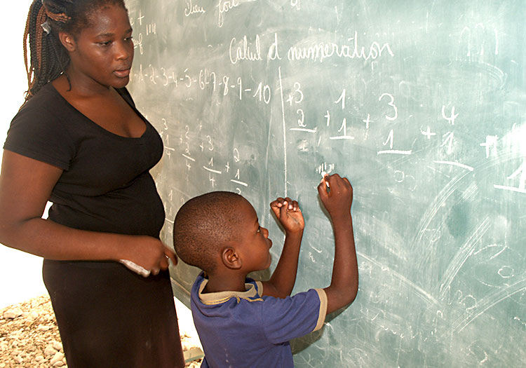 Young boy learning arithmatic at the blackboard
