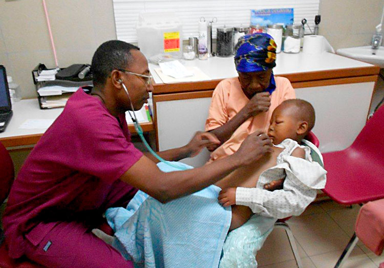 Dr. Marty treating a patient during Community health care in Haiti.