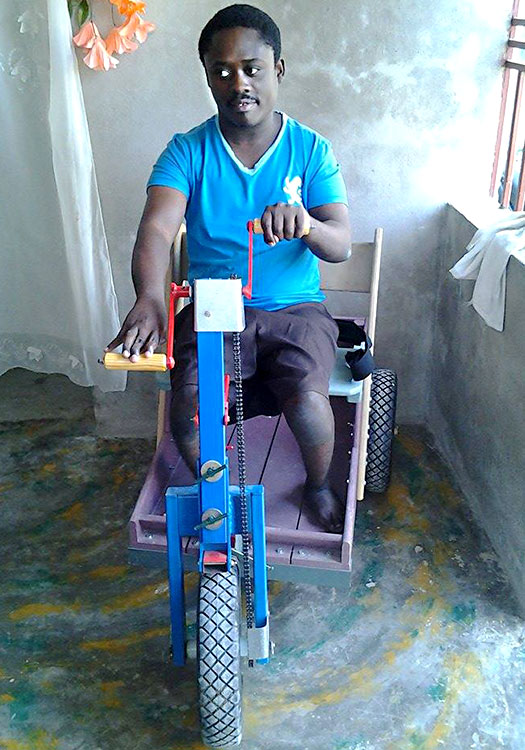 Edson Antoinie disabled riding PET device.Extraordinary Challenges for those with Special Needs in Haiti.