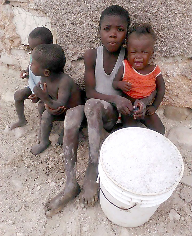 Haitian children work in the salt flats