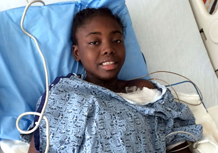 Dimelia in hospital bed at Shriners Hospital in Boston.