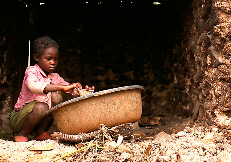Young girl washing clothes each day in Haiti.