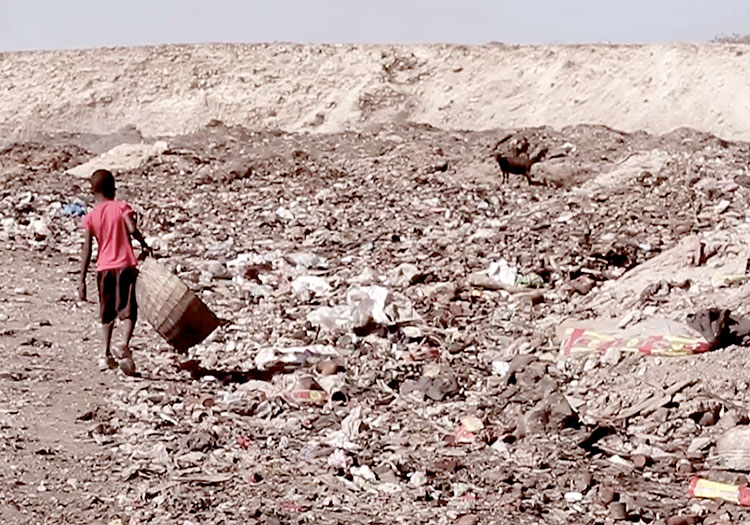 Young child looking for food at the Truttier Dump site