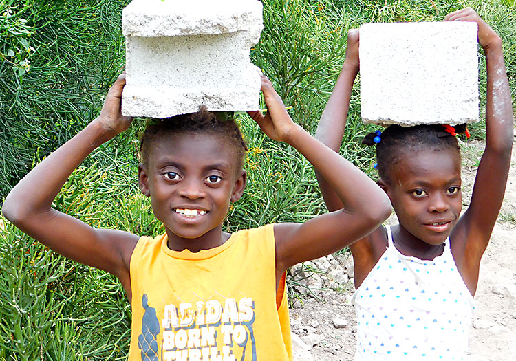 Children work each day in Haiti.
