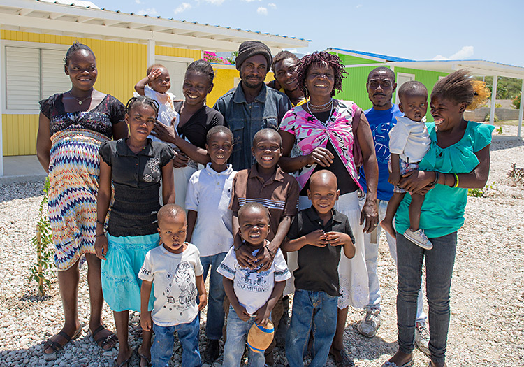 The family Pierre at their new home in Mirachle Village