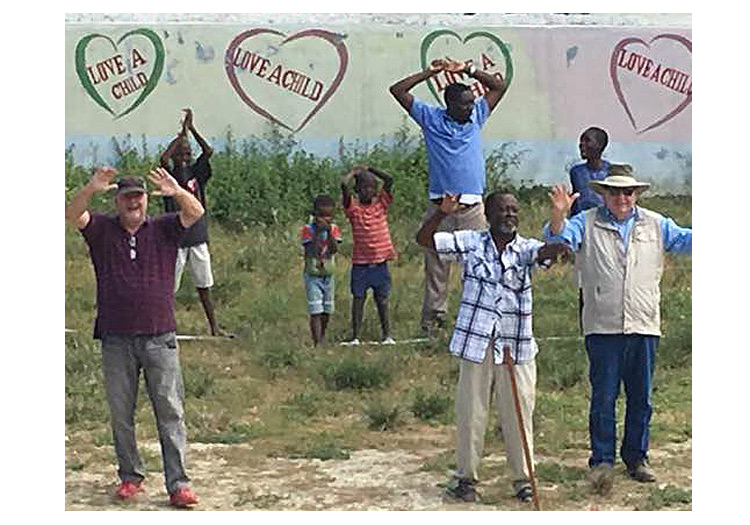 Orphaned children with David, Bobby and Pastor Claude standing where the new church will be built.