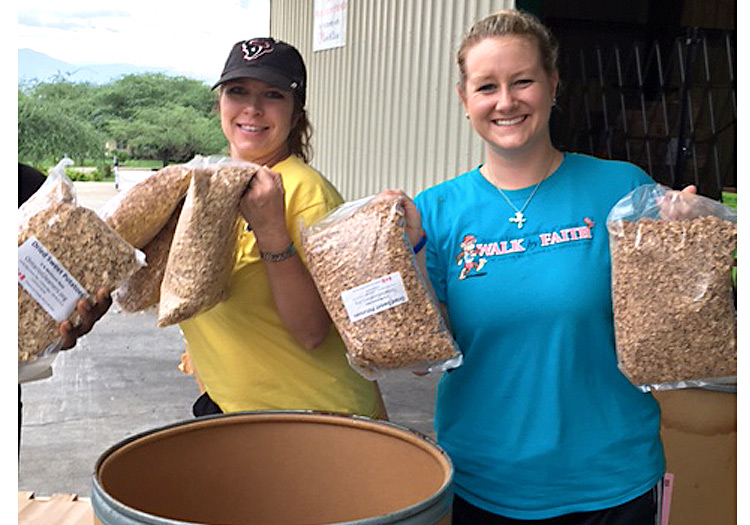 Julie and Kaeli pack up emergency relief food for local villages