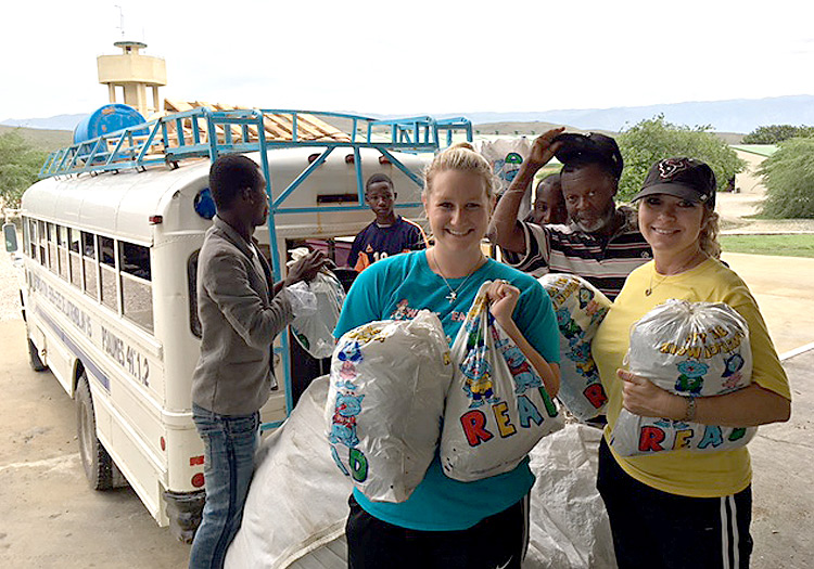 Kaeli and Julie help load food and disaster relive kits for Pastor Claude
