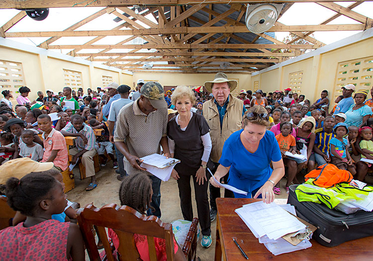 Injured Haitians gather in church with no roof.