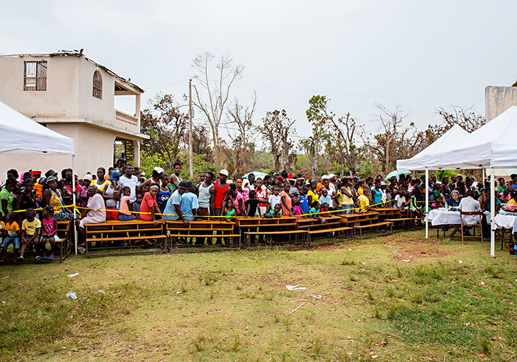 Haitians waiting in the rain for medical care.