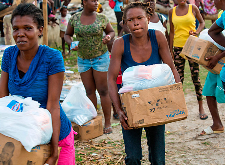 Haitians receiving disaster relief food and supplies.