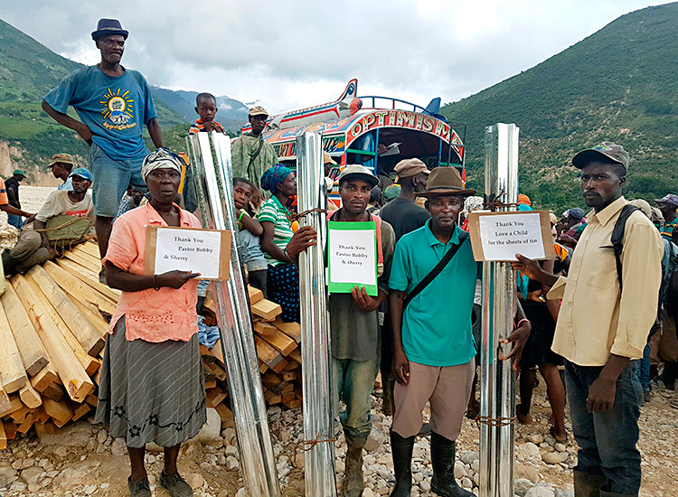 Building supplies to poor Haitians in the mountain areas.