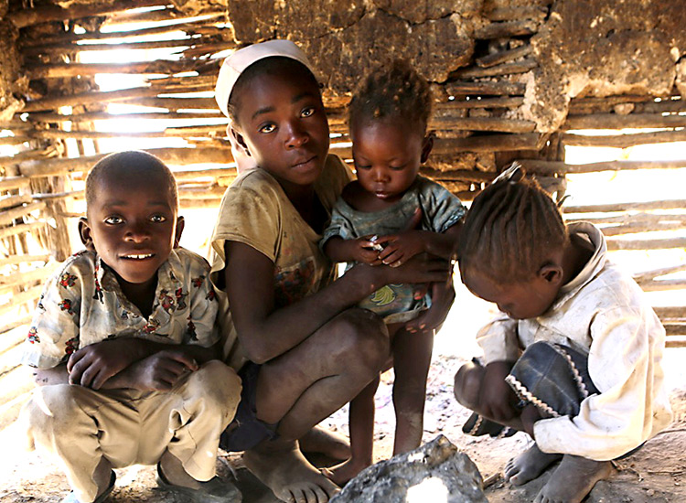 Poor Haitian children in mud hut