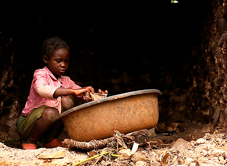 Young Haitian girl washing family's clothes