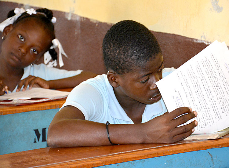 Haitian boy-studying in school