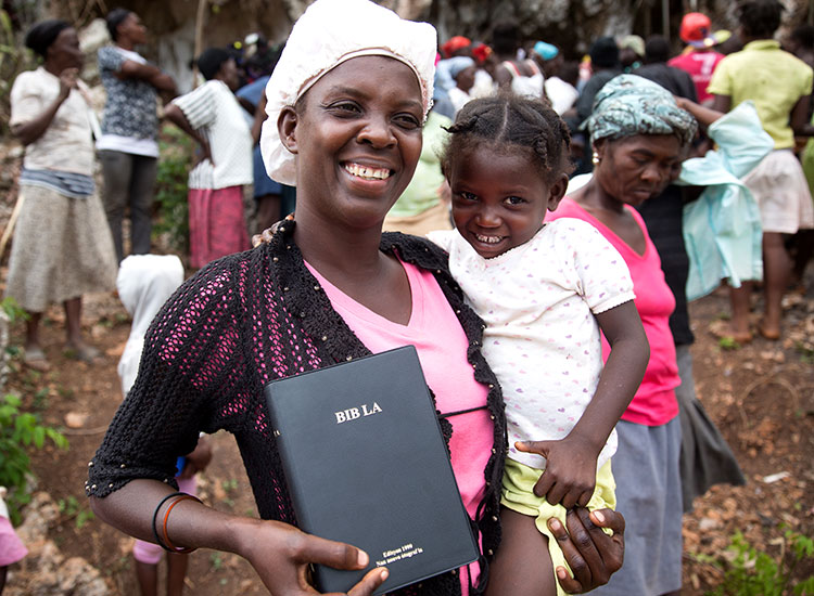 Haitan mother and child with Creole Bible