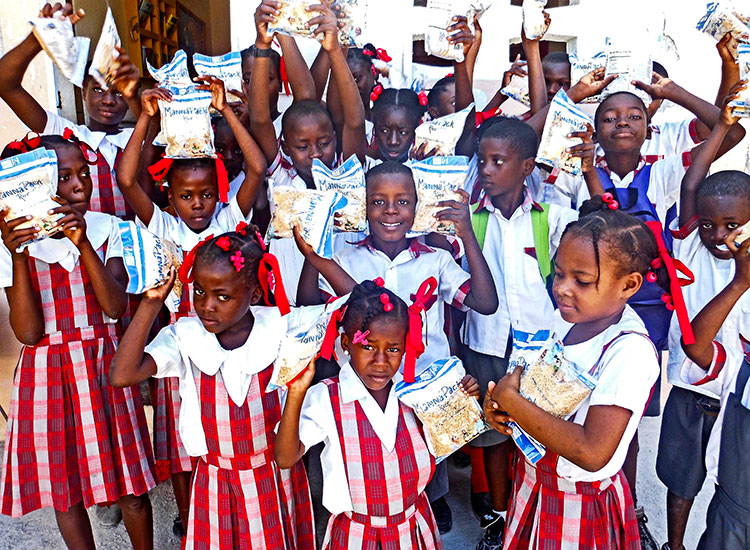 Feeding orphanage children in Haiti.