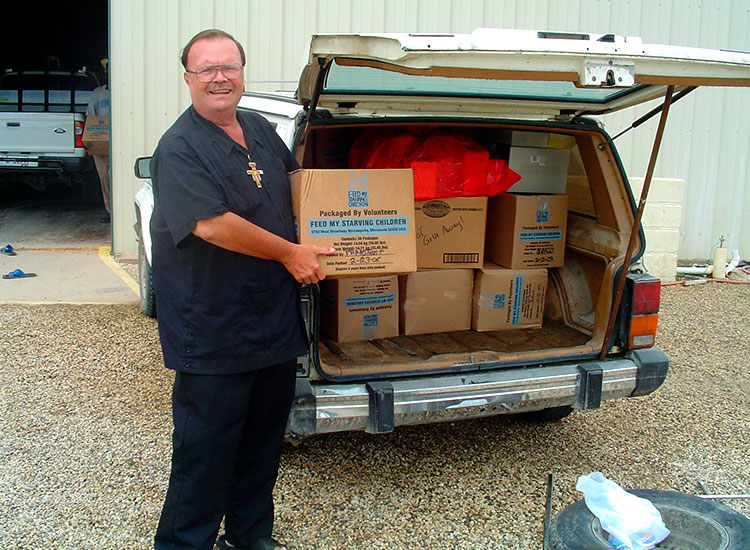 Missionaries pick up their boxes of food at the warehouse.