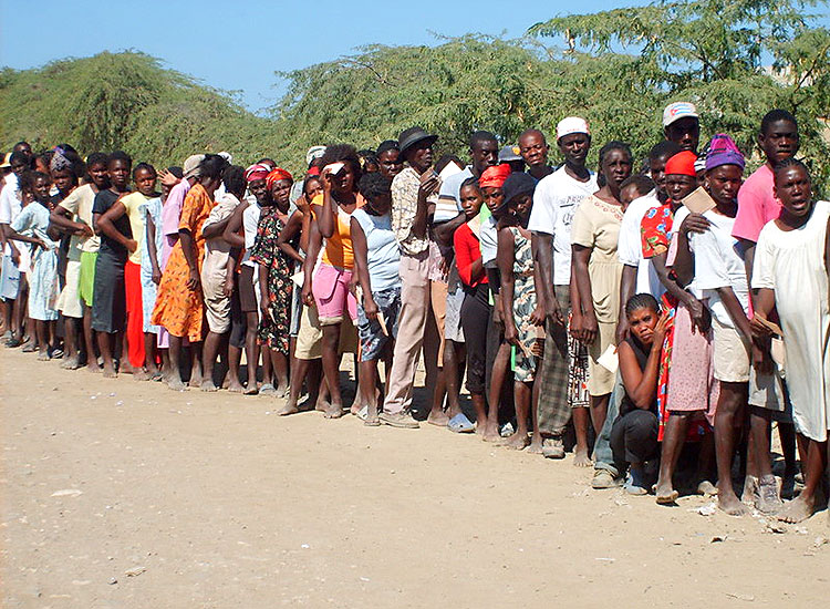Haitians wait to pick up their boxes of food.