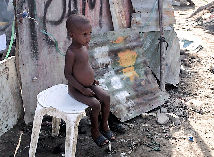 Children struggle to survive in the garbage dumps of Cité Soleil.