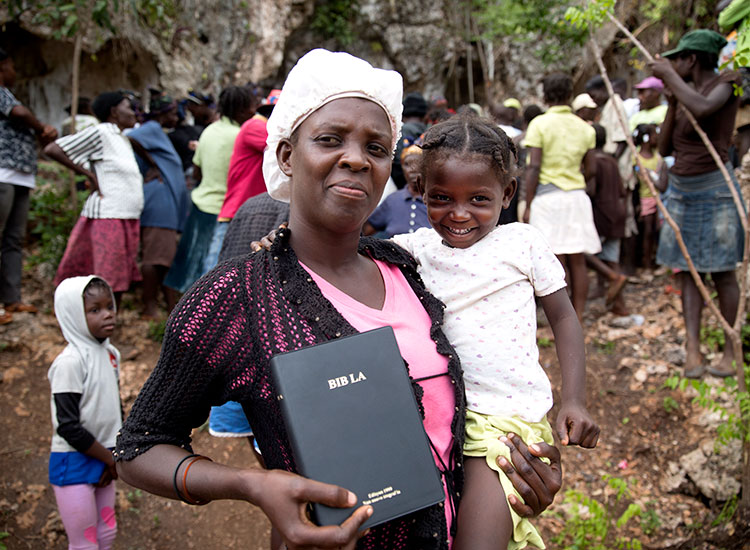 Haitian families living in the cave. Bobby took them food and Creole Bibles. 