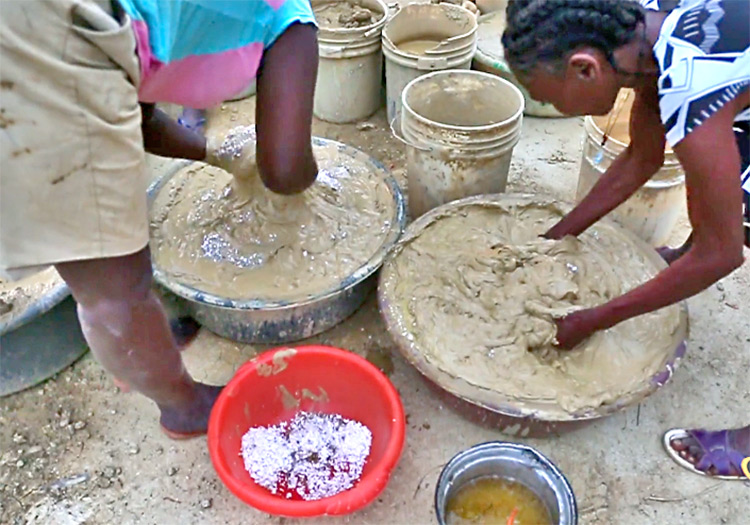 Women in Sabaterre make mud cookies.
