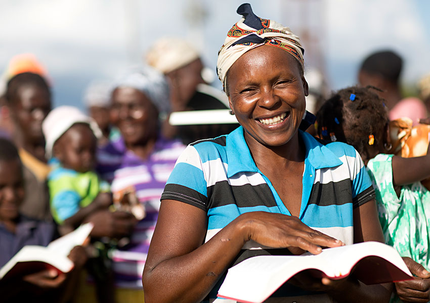 Haitian woman is happy with her new Creole Bible