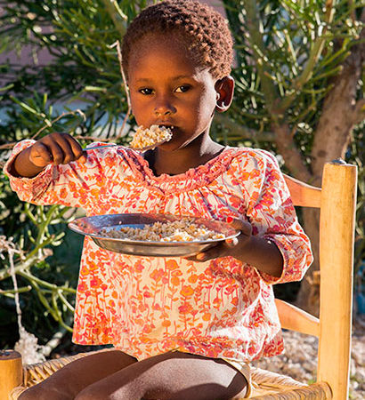 Young girl eating nutritious food.