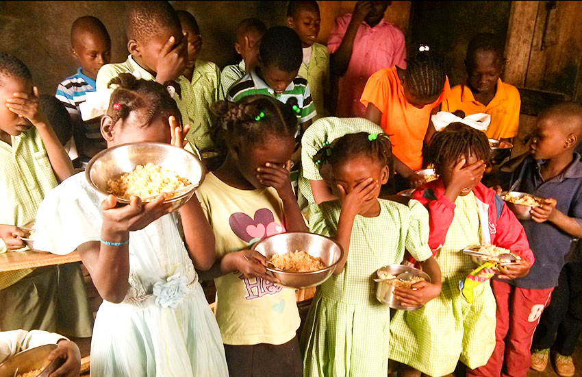 These little Haitian children are so thankful for their food, as they say prayers before their meal