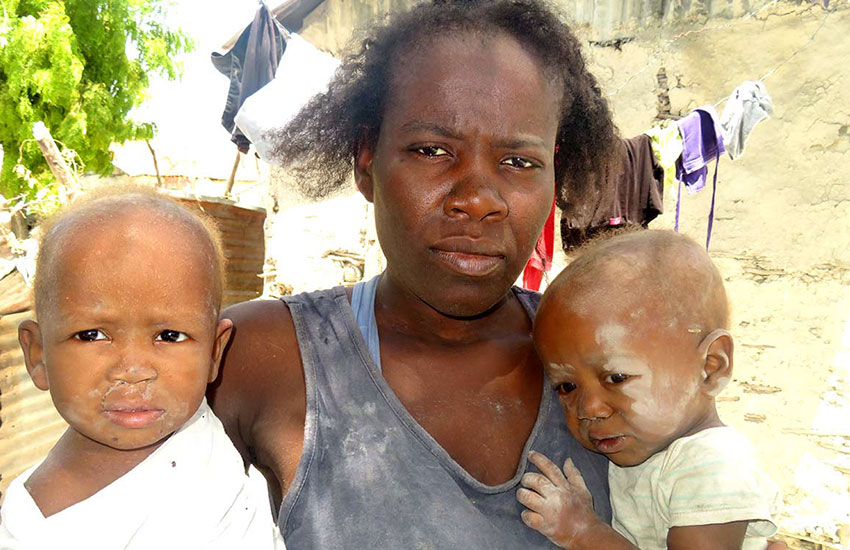Mother with starving children in Haiti.