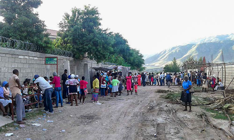 Haitians waiting outside Jesus Healing Center to see doctors.