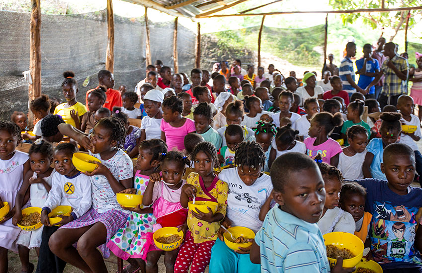 Feeding children in Fond Bayard, Haiti.