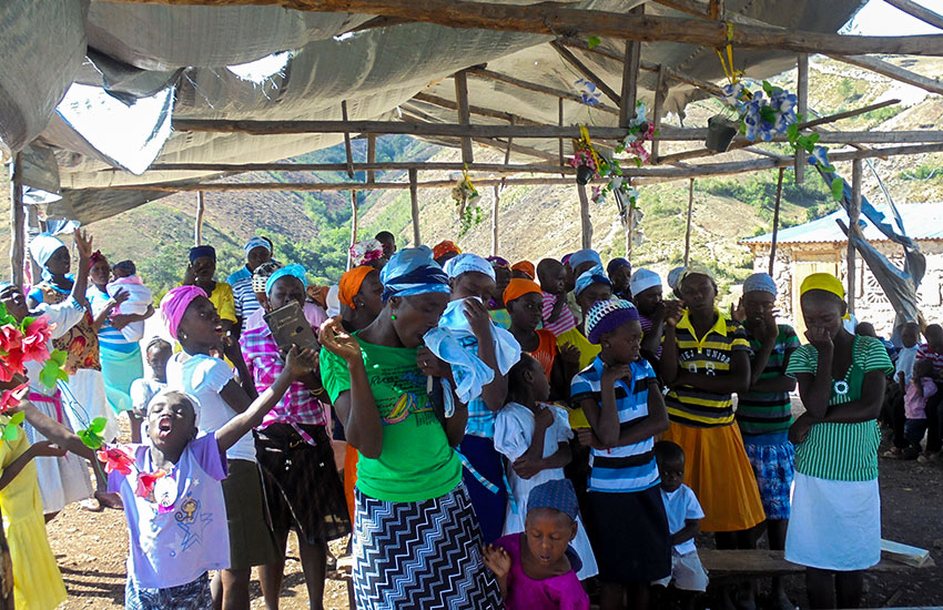 The poor gathered in the stick church as Bobby ministered the Word of God and we served about 500 hot meals.