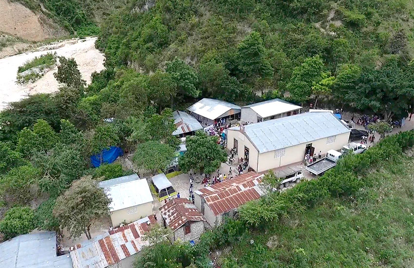 The village sits along the banks of a large dried up riverbed.