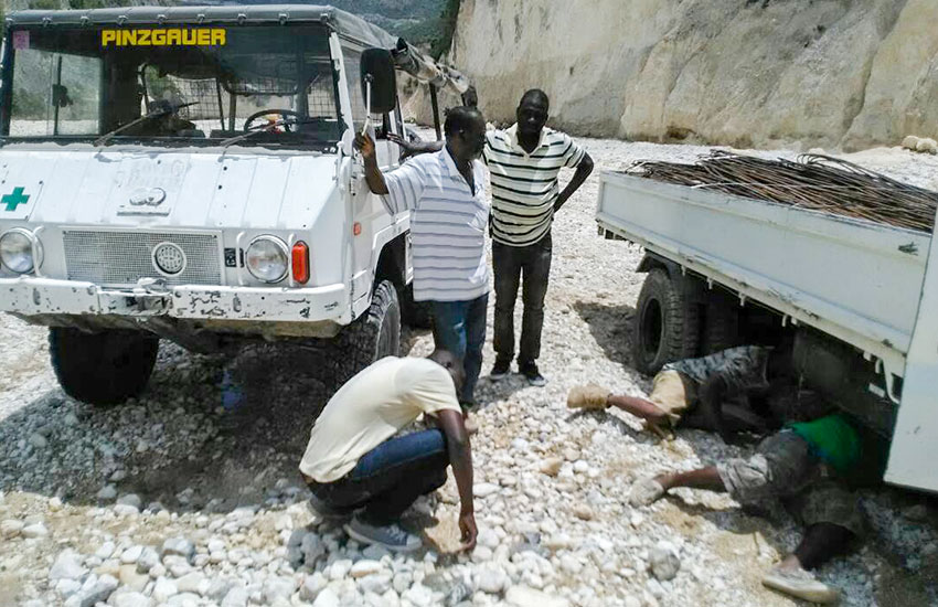 Our four-wheel drive truck, loaded with wood and supplies for the new schoolrooms, breaks down in the rocky riverbed to Lastik.