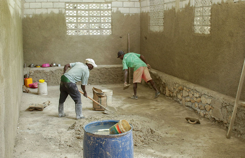 Local workers building up the inside of one of the new classrooms.