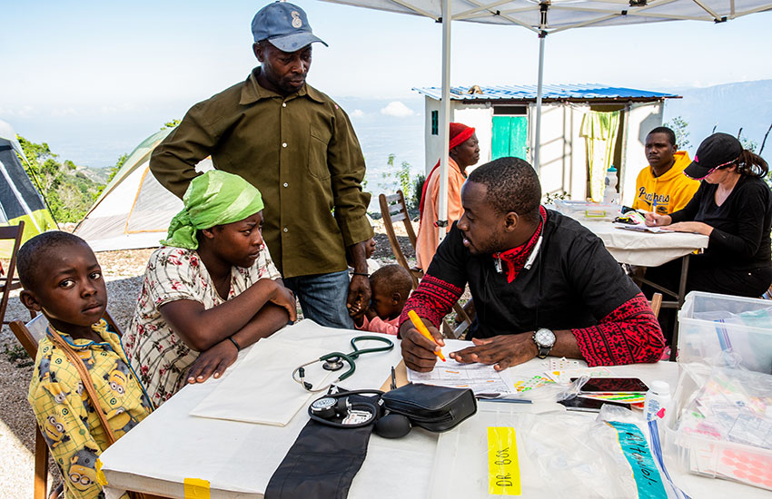 Our Haitian doctor consults with one of the poor patients.