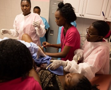 Midwives and nurses at the Birthing Center Delivering a Baby
