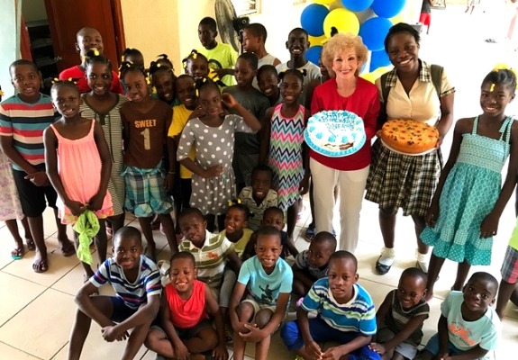 Here, Sherry Burnette, stands with just some of the many children cared for at our Children's Home in Haiti.