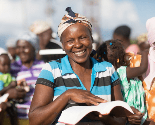 Woman in Peyi Pouri holding Bible